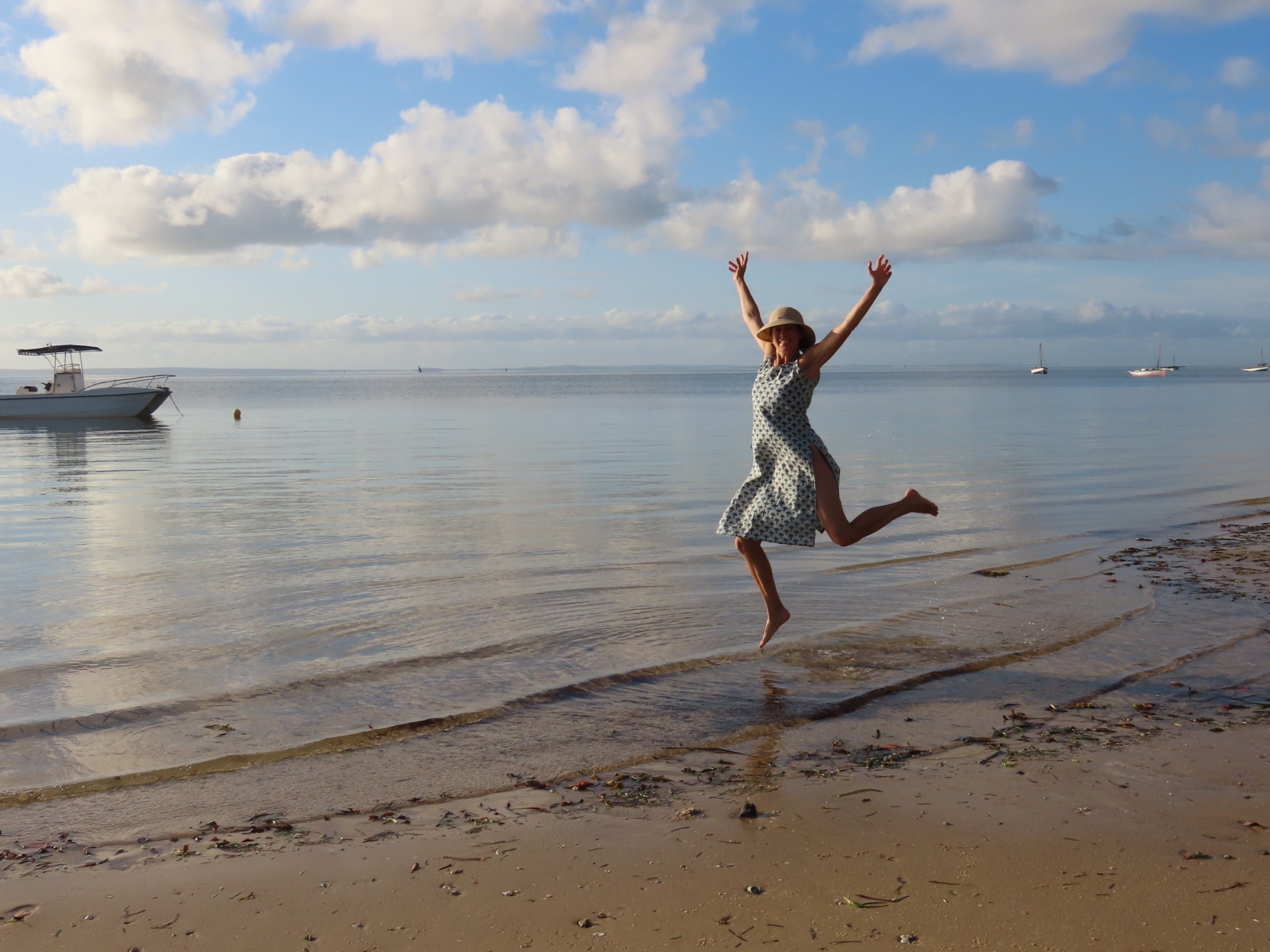 Nina jumping joyfully beside the water